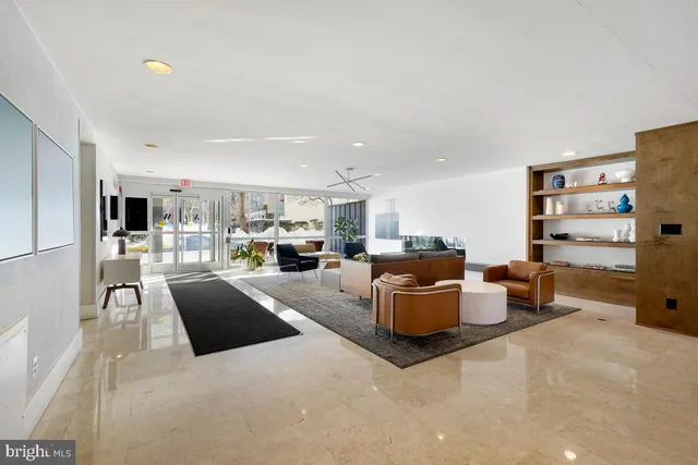 a living room with furniture and a dining table