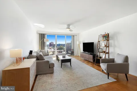 a sign that is sitting in front of a tree