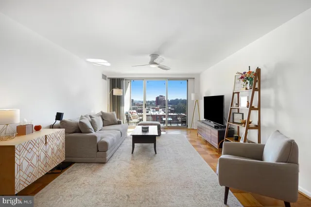 a living room with furniture flat screen tv and a fireplace