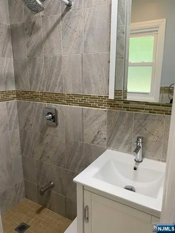 a bathroom with a sink a mirror and a window