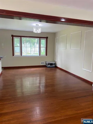 a view of room with window and hardwood floor