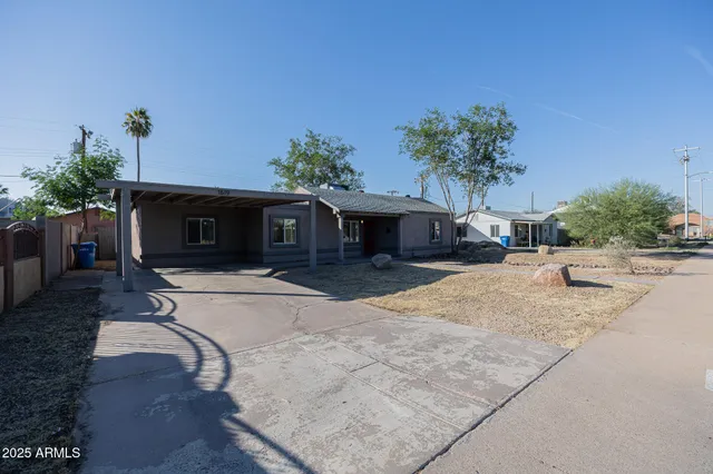 a front view of a house with a yard and a garage