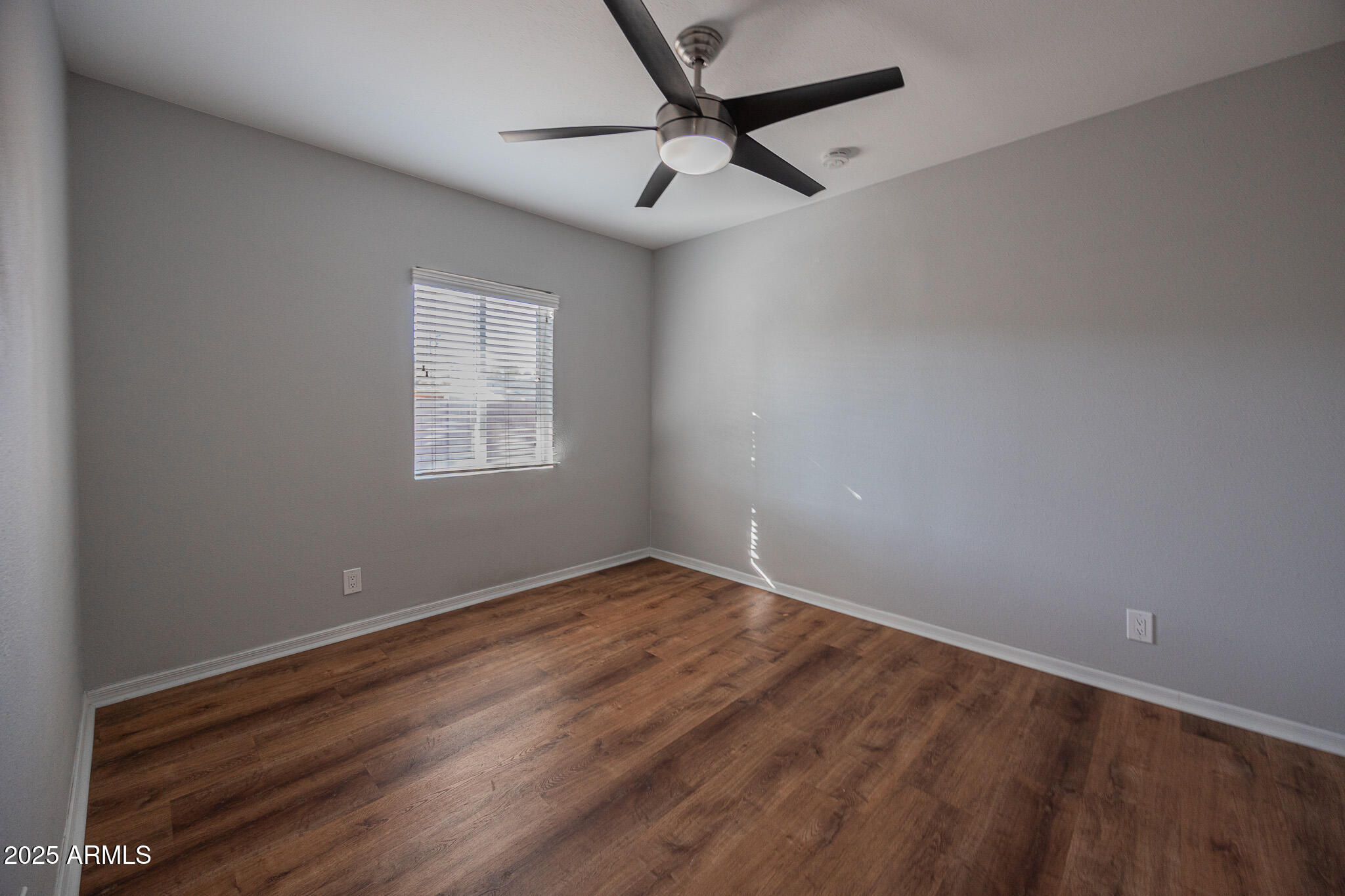 1619 East Whitton Avenue Phoenix, AZ 85016 - Photo 15 of 22 an empty room with a window and a fan