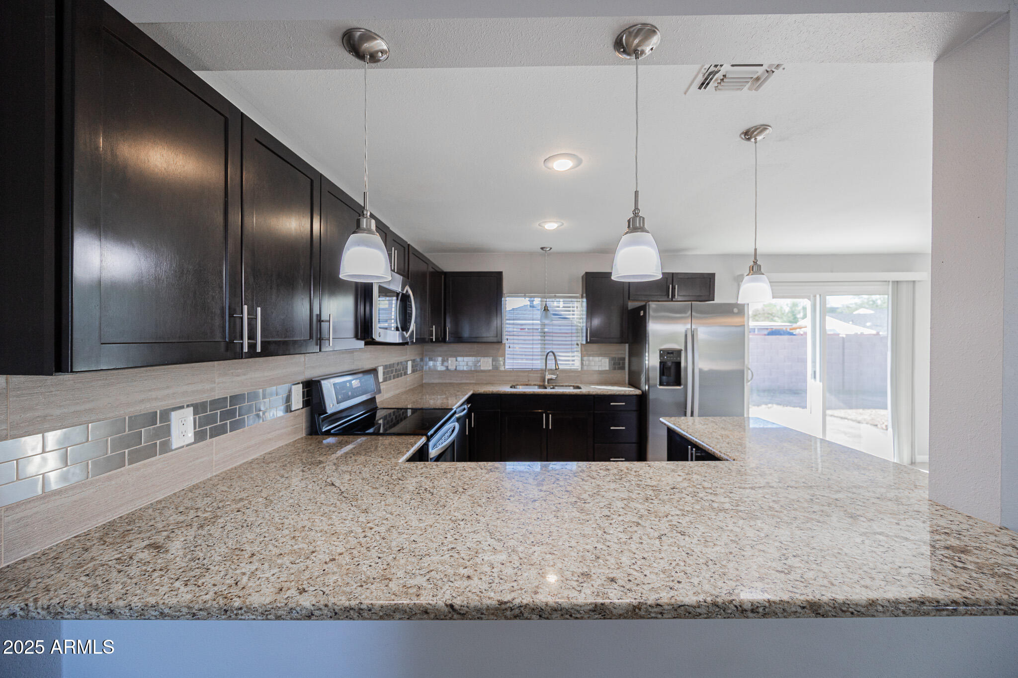 1619 East Whitton Avenue Phoenix, AZ 85016 - Photo 6 of 22 a large kitchen with stainless steel appliances granite countertop a stove a sink and a granite counter top