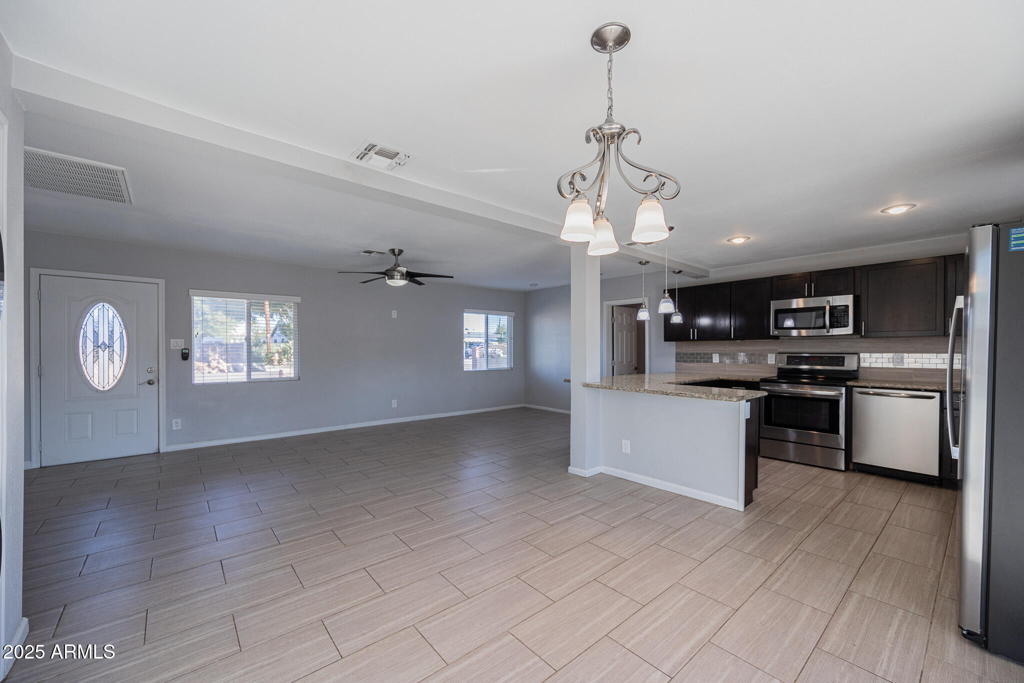 1619 East Whitton Avenue Phoenix, AZ 85016 - Photo 9 of 22 a view of kitchen with sink microwave and stove top oven