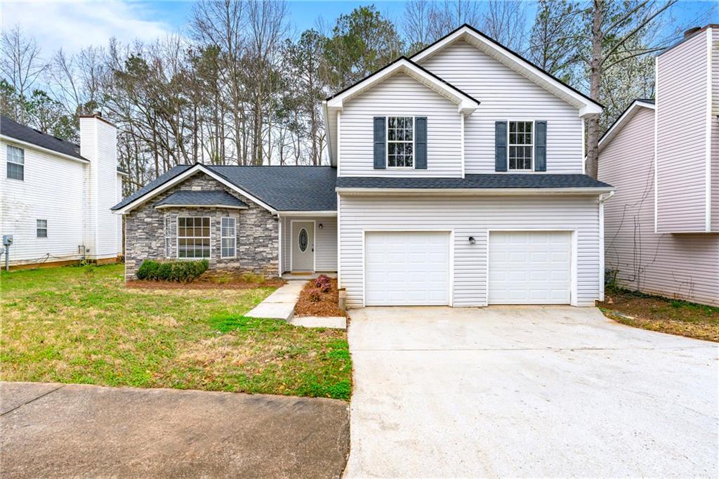 2105 Creekview Trail Decatur, GA 30035 - Photo 1 of 1 a front view of a house with a yard and garage