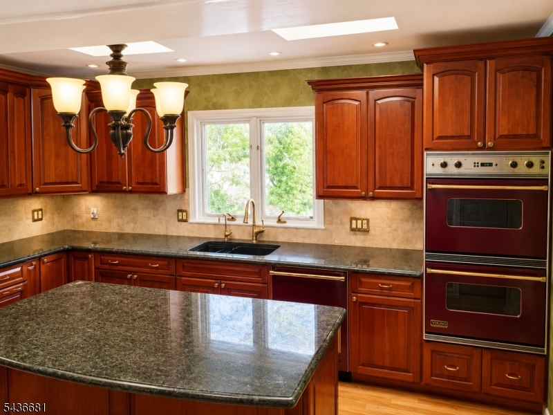 178 East Lindsley Road, Unit 2 Cedar Grove, NJ 07009 - Photo 6 of 28 a kitchen with wooden cabinets a sink and a stove with wooden floor