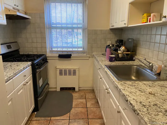 a kitchen with a sink stove and cabinets