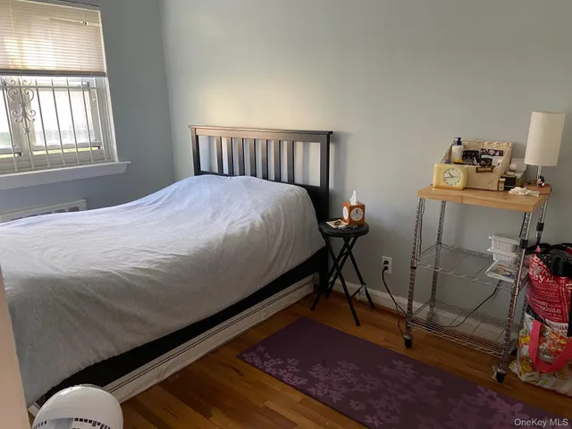 a bed sitting in a bedroom next to a window