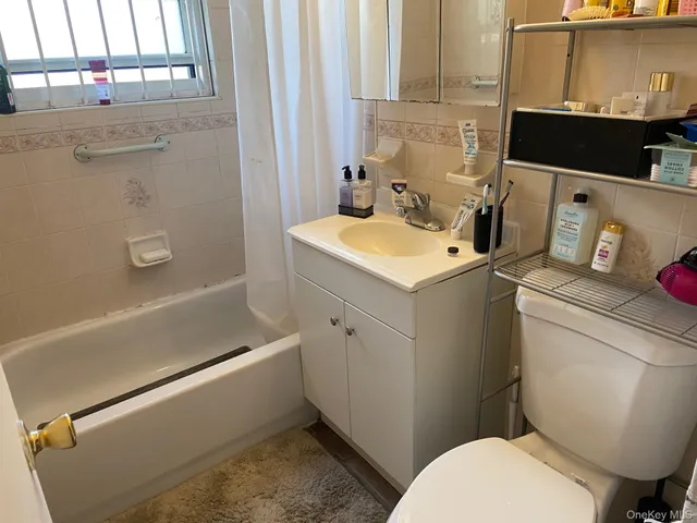 a bathroom with a sink toilet and tub