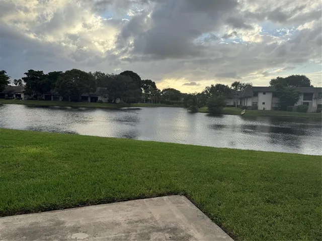 a view of a lake with houses in back