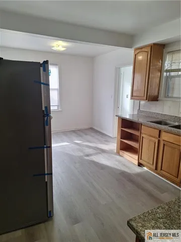 a view of kitchen with wooden floor and electronic appliances