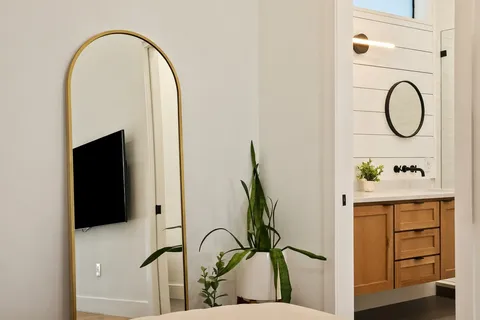 a bedroom with a bed and a flat screen tv
