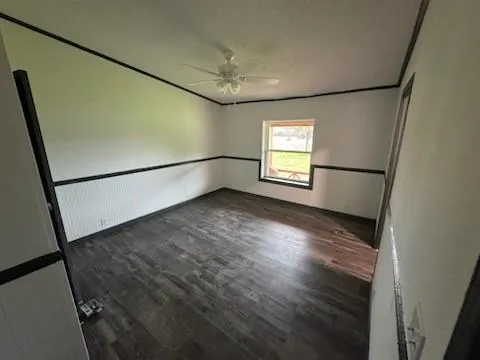 a view of empty room with window and stairs