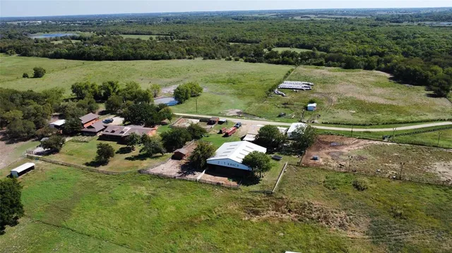 an aerial view of a house with yard