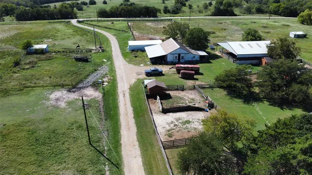 a aerial view of a house with big yard