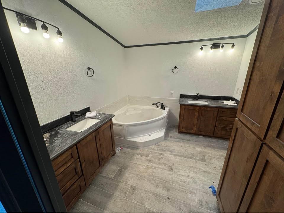 16283 County Road 1004 Blue Ridge, TX 75424 - Photo 19 of 19 a bathroom with a granite countertop sink toilet and bathtub