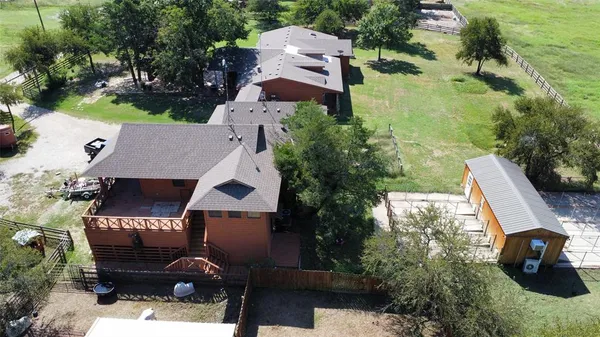 an aerial view of a house with garden space and street view