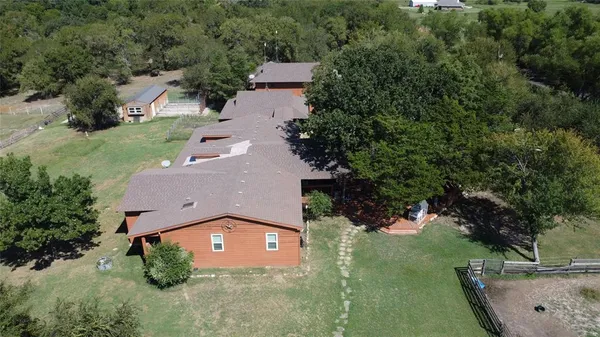 an aerial view of a house with yard swimming pool and outdoor seating