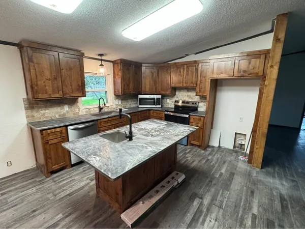 a kitchen with a sink a counter top space and appliances