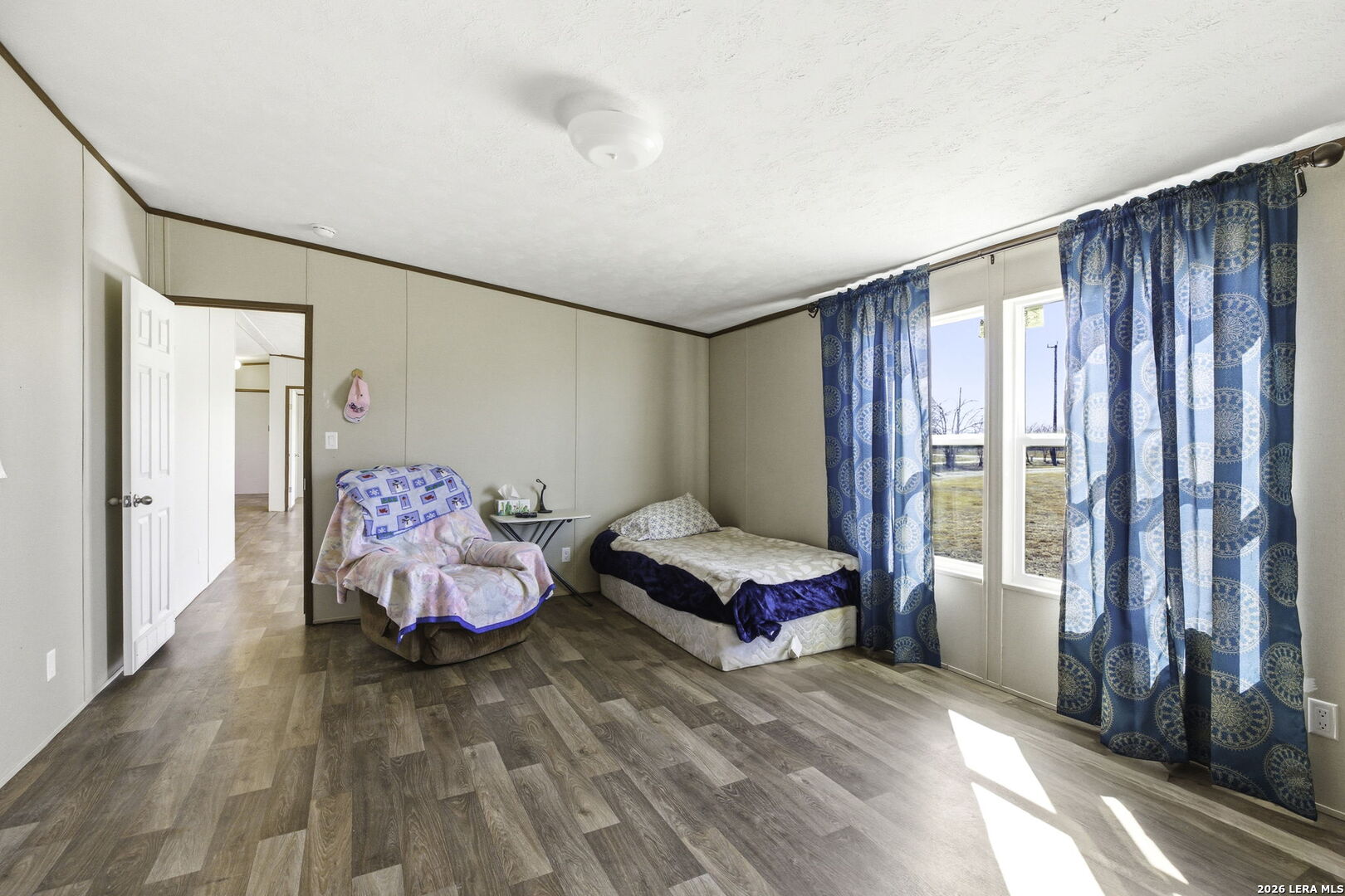 393 West County Road 5719 Devine, TX 78016 - Photo 13 of 26 a spacious bedroom with a bed and a window