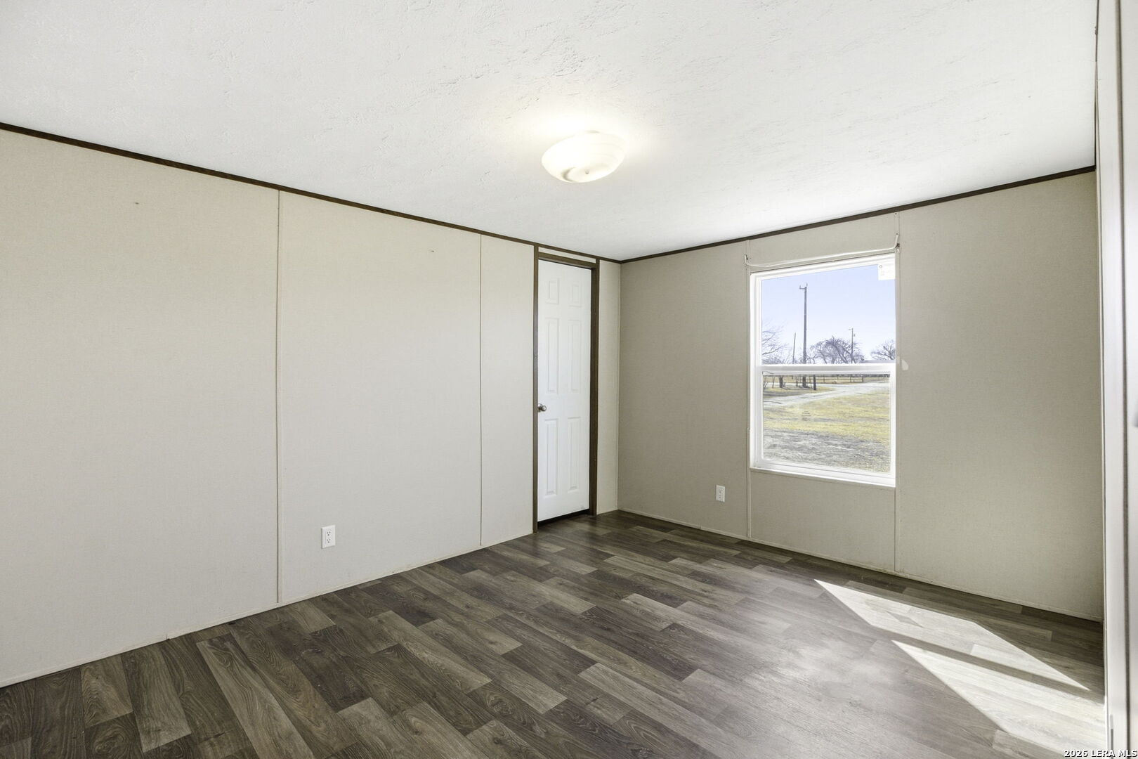 393 West County Road 5719 Devine, TX 78016 - Photo 15 of 26 a view of an empty room with a window