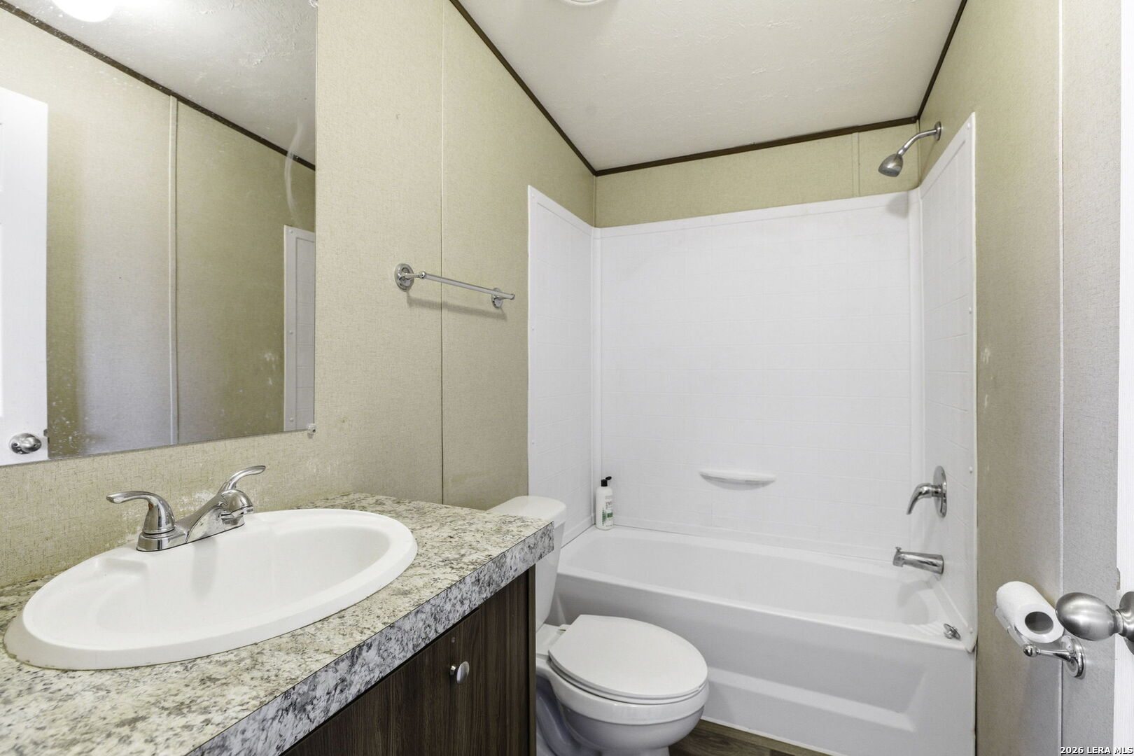 393 West County Road 5719 Devine, TX 78016 - Photo 16 of 26 a bathroom with a granite countertop sink toilet and shower