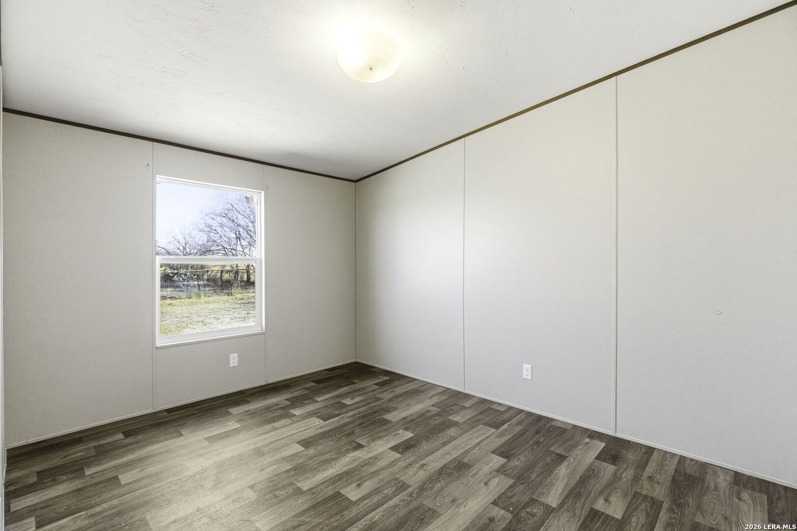 393 West County Road 5719 Devine, TX 78016 - Photo 17 of 26 an empty room with a window