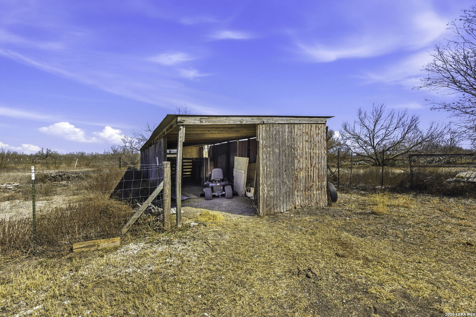 393 West County Road 5719 Devine, TX 78016 - Photo 21 of 26 a view of a wooden house with a outdoor space