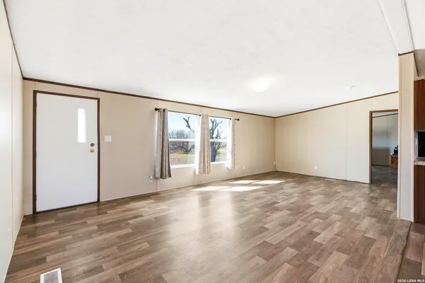 a view of kitchen with stove and cabinets