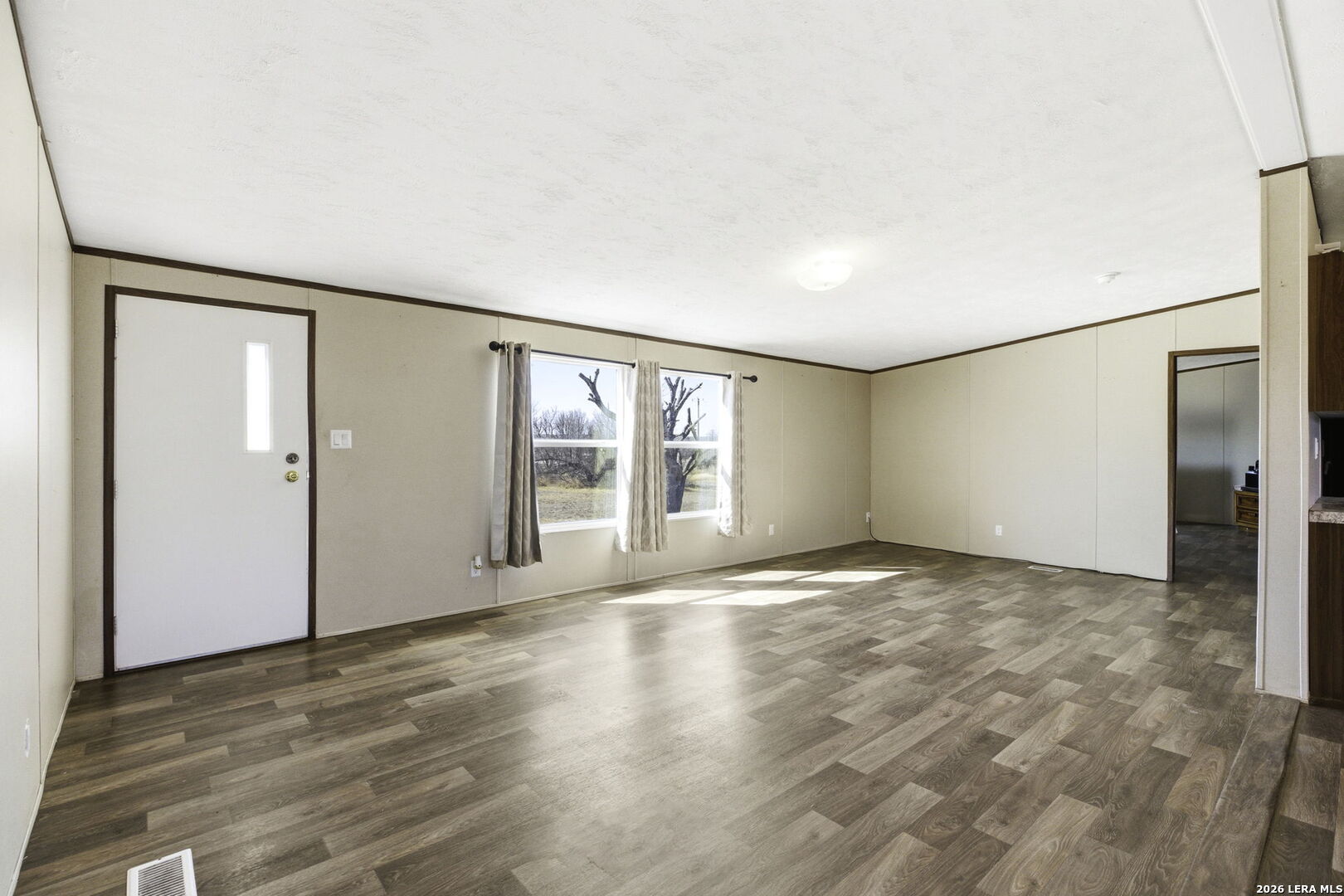 393 West County Road 5719 Devine, TX 78016 - Photo 5 of 26 a view of an empty room with a window