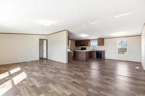 a view of a kitchen with a sink and a refrigerator