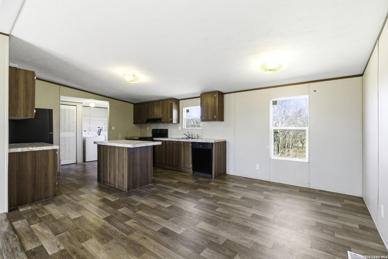 393 West County Road 5719 Devine, TX 78016 - Photo 9 of 26 a view of kitchen with window a sink and a refrigerator