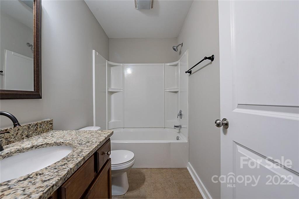 527 Alderman Lane Fort Mill, SC 29715 - Photo 12 of 17 a bathroom with a granite countertop sink a toilet and shower