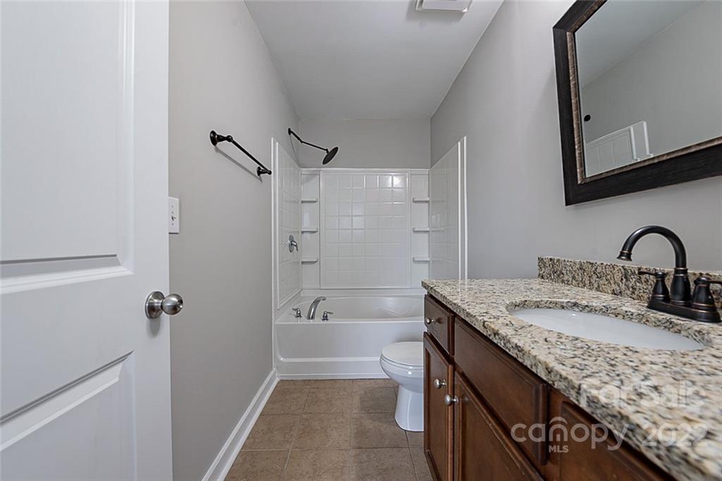 527 Alderman Lane Fort Mill, SC 29715 - Photo 13 of 17 a bathroom with a granite countertop sink a mirror and shower
