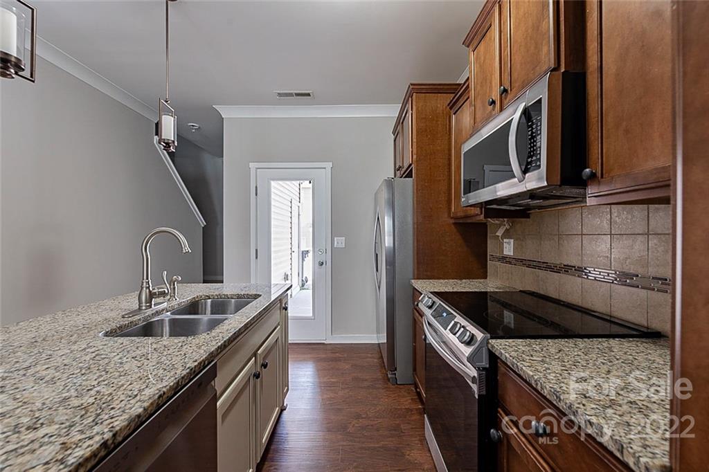 527 Alderman Lane Fort Mill, SC 29715 - Photo 4 of 17 a kitchen with stainless steel appliances granite countertop a sink stove and cabinets