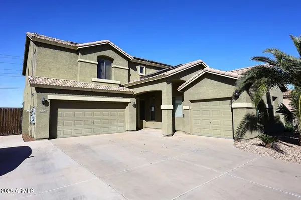 a view of a house with a yard and garage