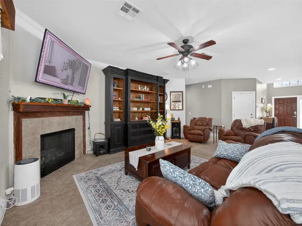 a living room with furniture a fireplace and a flat screen tv