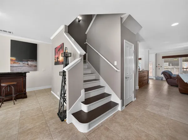 a living room with furniture and a ceiling fan