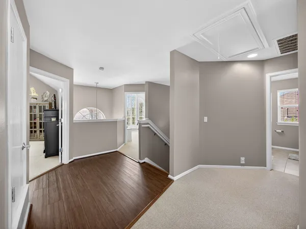 a bathroom with a double vanity sink a large mirror and a bathtub