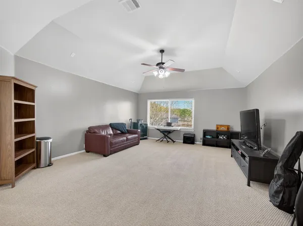 a bathroom with a double vanity sink a toilet a mirror and shower