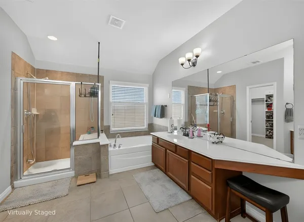 a spacious bedroom with bed and a chandelier