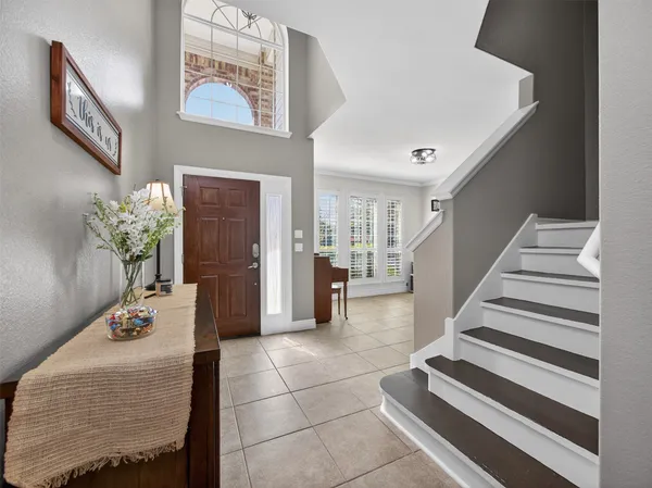 a lobby with furniture and potted plant