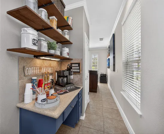 a view of a hallway with dining table and chairs