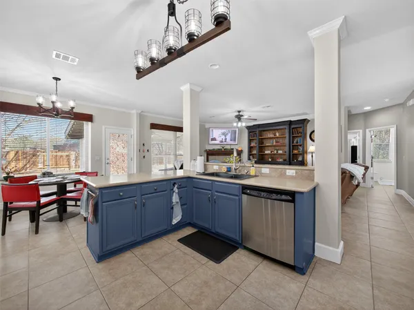a large kitchen with kitchen island granite countertop a large counter top and stainless steel appliances