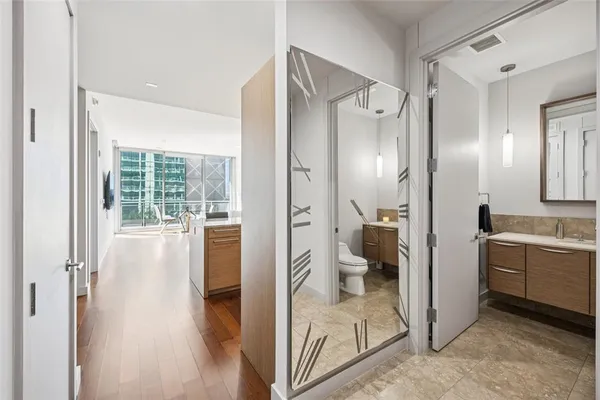 a view of a kitchen with sink large windows and wooden floor