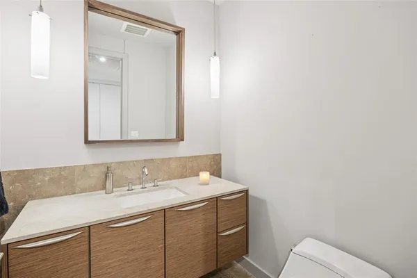 a kitchen with kitchen island a stove a table and chairs