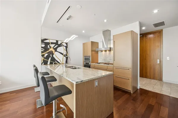a kitchen with granite countertop a sink and a stove top oven