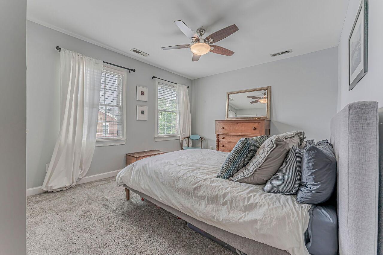 106 Hatfield Lane Raleigh, NC 27603 - Photo 16 of 29 a bedroom with a large bed and a ceiling fan