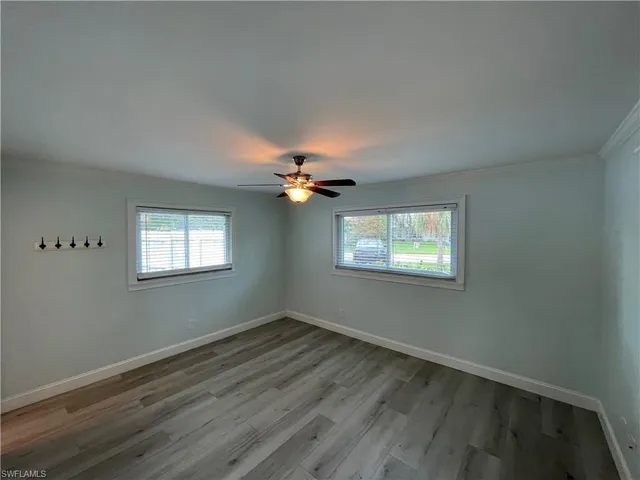 wooden floor in an empty room with a window